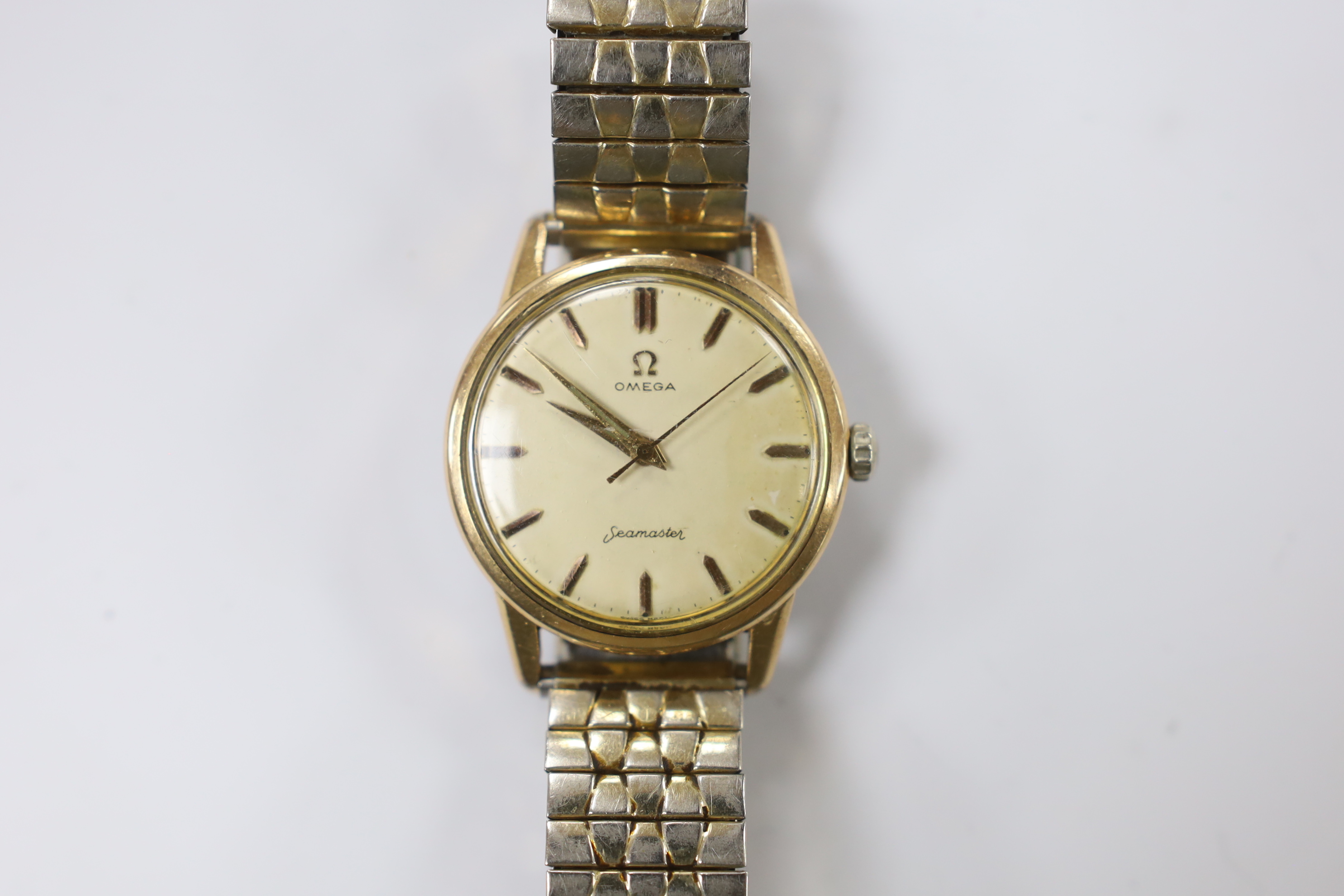 A gentleman's steel and gold plated Omega Seamaster manual wind wrist watch, cased diameter 35mm, on a later associated flexible bracelet.